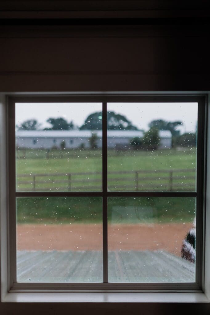 View outside the window in the bridal suite of the Farmhouse with raindrops speckled on the window