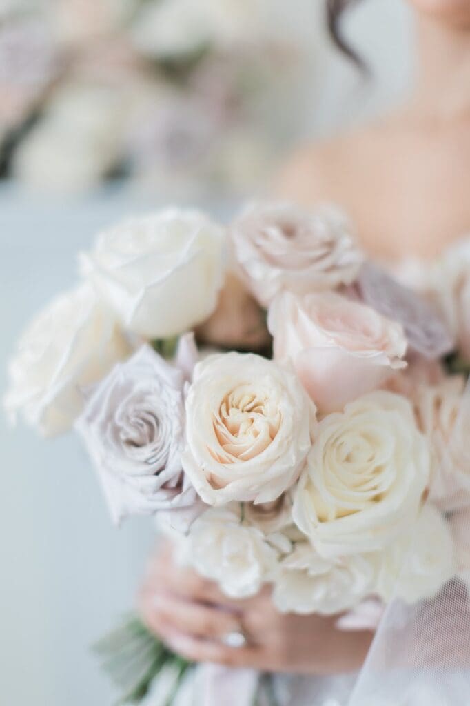 Soft pastel colored roses in varied shades of white, blush, and very soft lavender