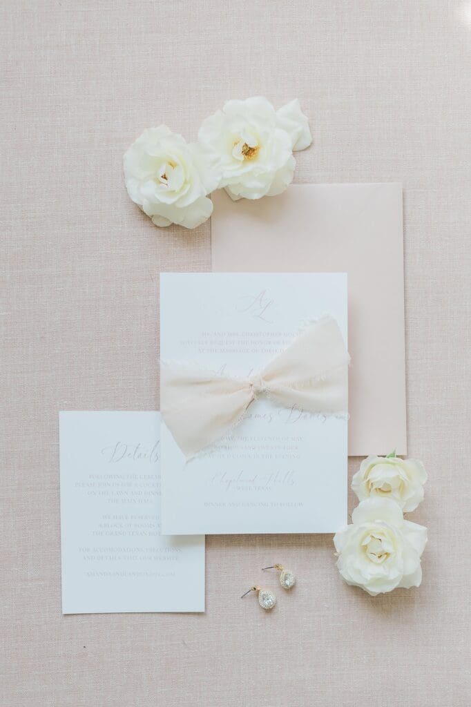 Soft dusty pink elegant flatlay of wedding invites
