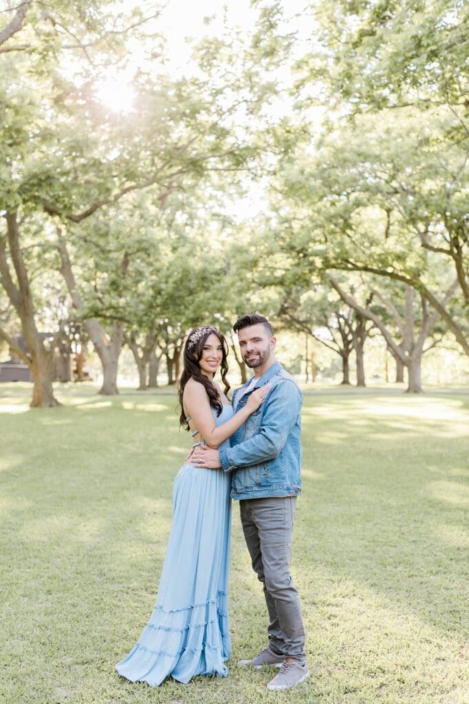 Traditional bride and groom portrait smiling at the camera for their orchard at caney creek wedding