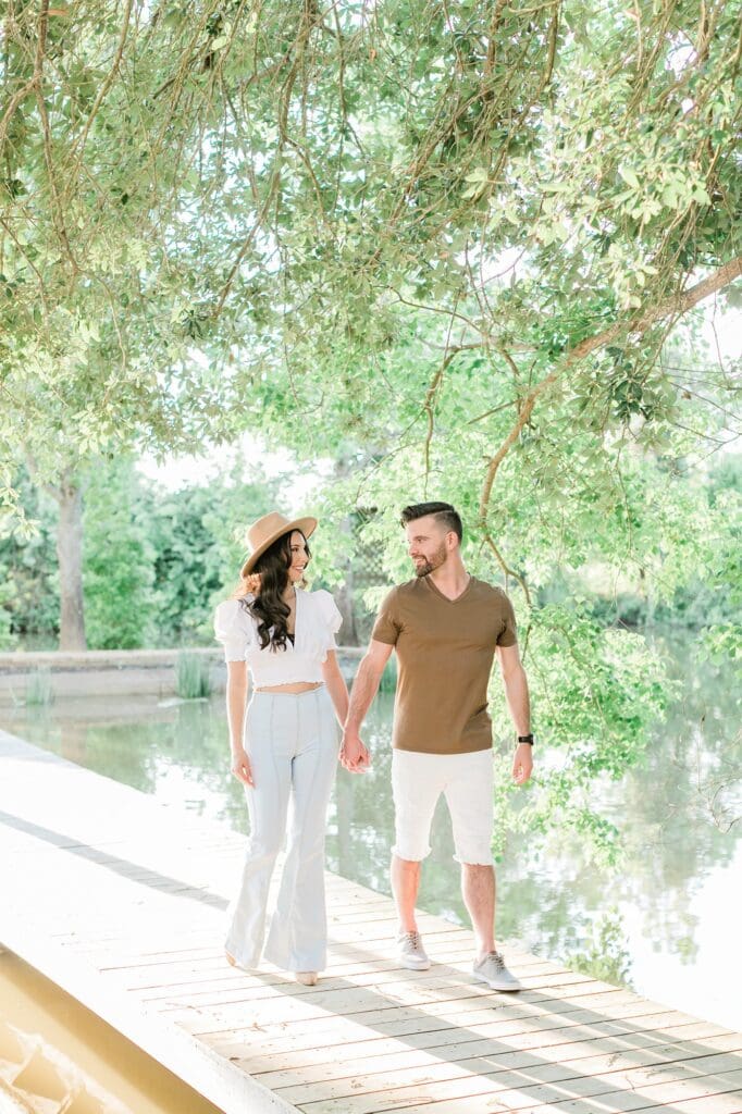Bride and groom walking on the dock at the orchard at caney creek for their engagement session