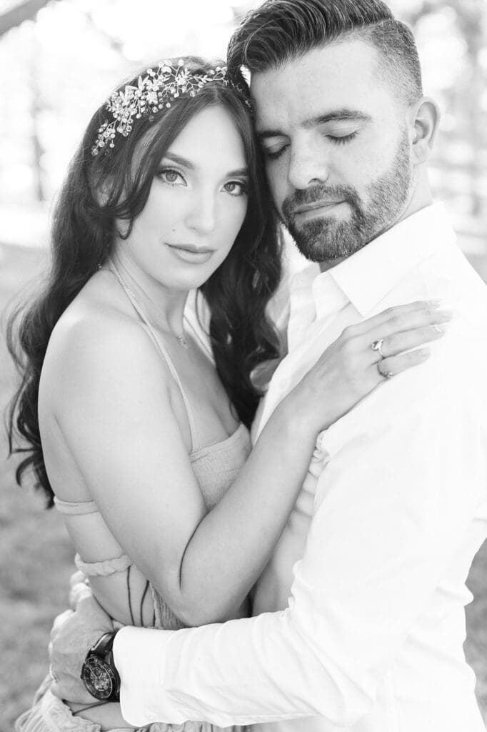 Black and white editorial portrait of couple for their engagement session at the orchard at caney creek
