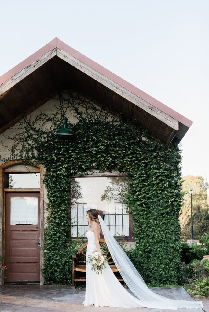Bride walking in front of the bridal suite for her bridal portraits at Olde Dobbin Station