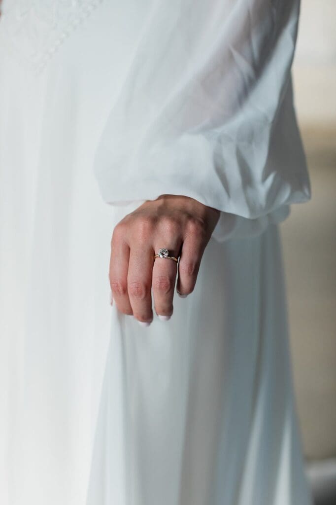 Close up of bride holding her dress and showing off her engagement ring for her bridals at Olde Dobbin Station