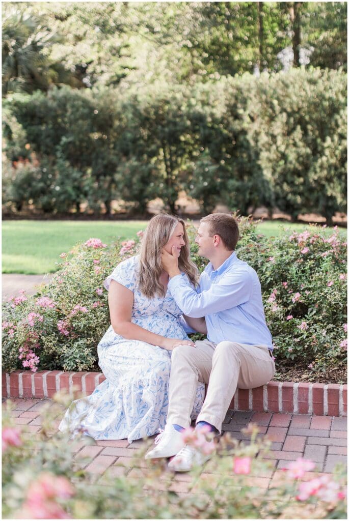 Couple sitting together on garden path during Mercer Botanic Gardens engagement session