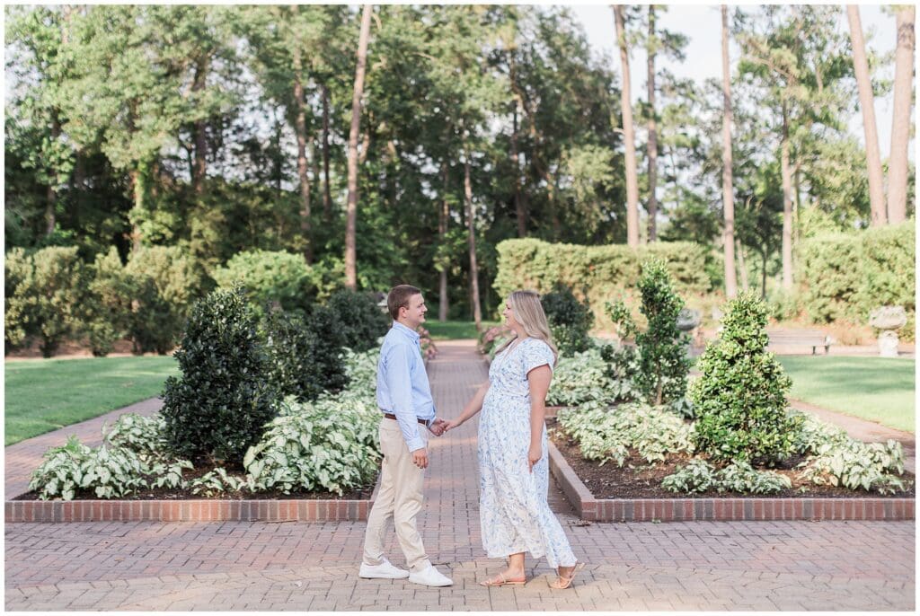 Romantic engagement session at Mercer Botanic Gardens with tree-lined paths in Houston Texas