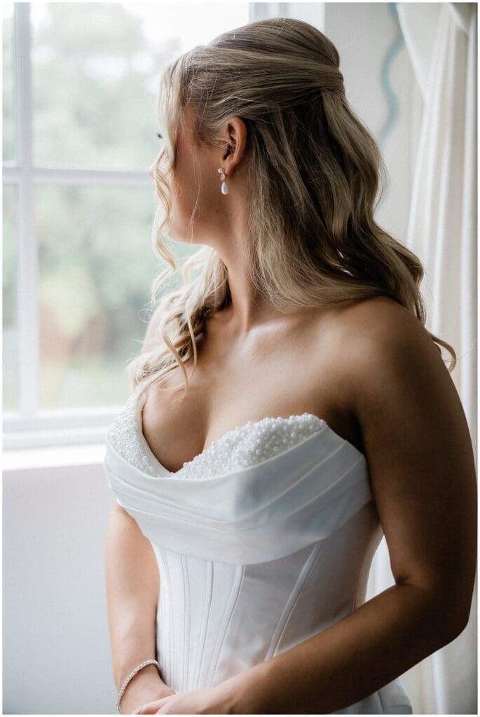Bride looking out at the chapel at Addison Woods