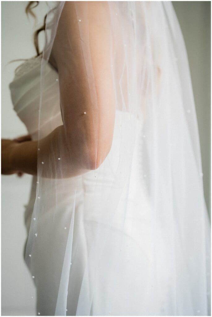 Bride waiting to go outside for bridesmaids portraits at Addison Woods