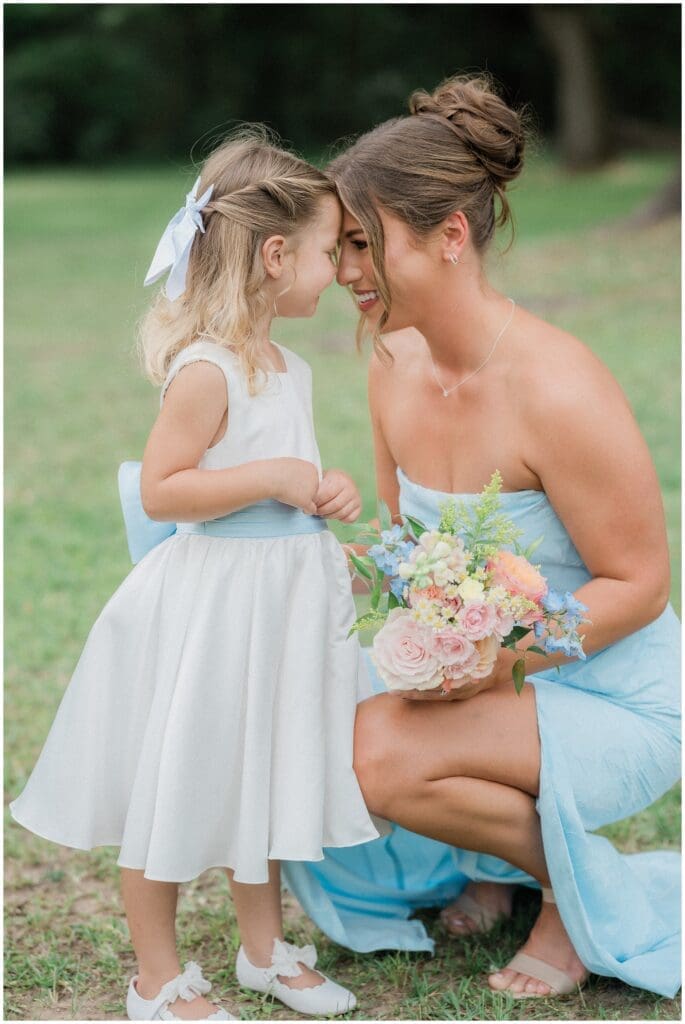 Bridesmaids smiling at flower girl at Addison Woods