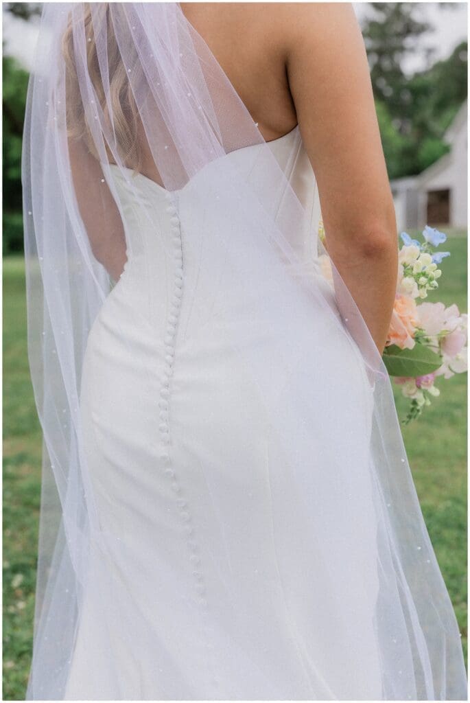 Details of the back of the brides wedding dress at Addison Woods