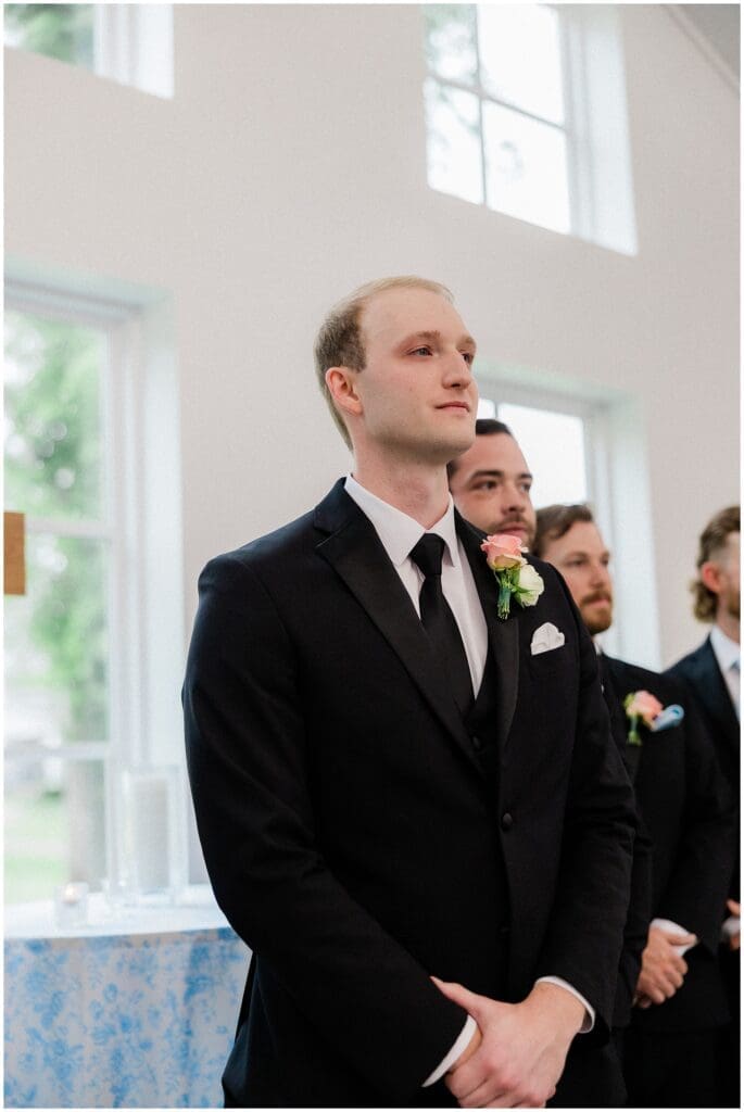 Groom becoming emotional and crying while bride walks down the aisle at Addison Woods