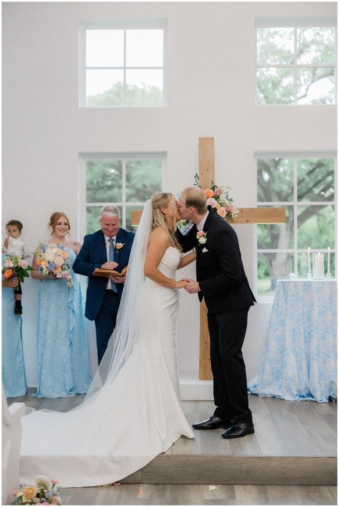 Bride and grooms first kiss as a married couple at Addison Woods