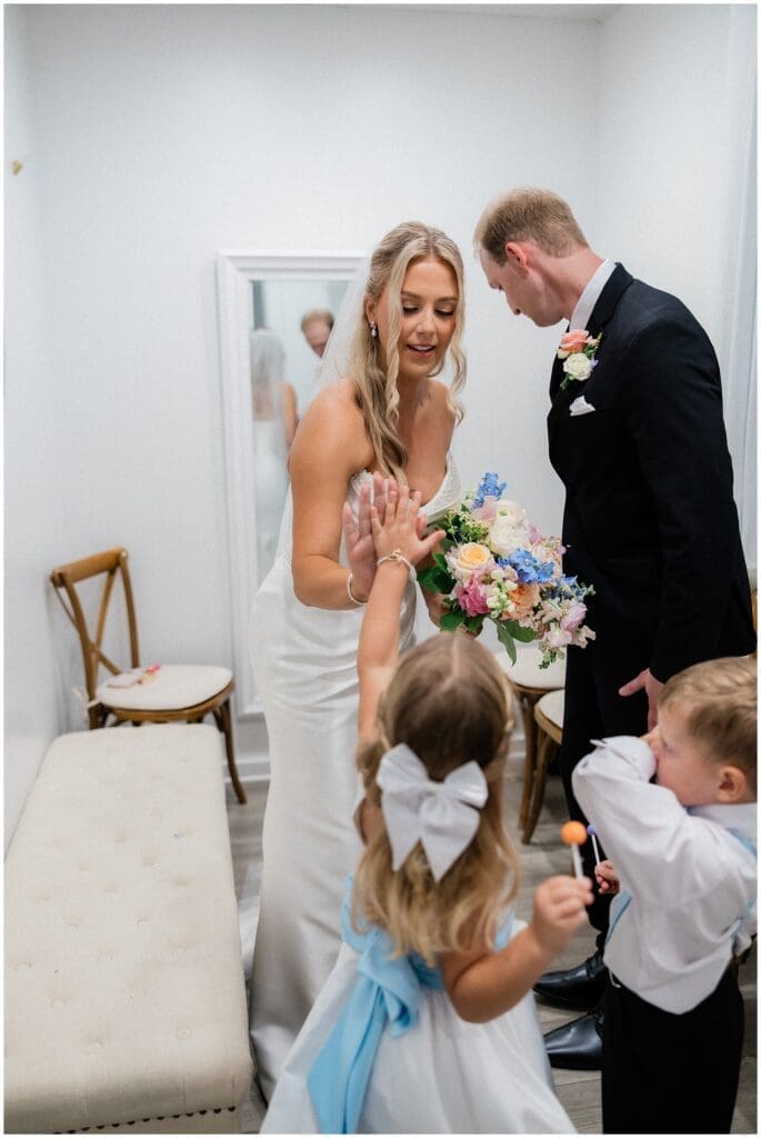 Flower girls high fiving the bride at Addison Woods