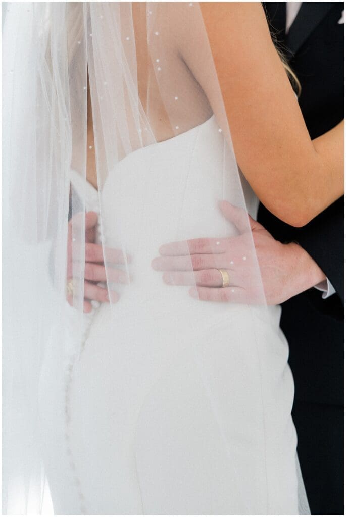 Groom holding brides waist at Addison Woods