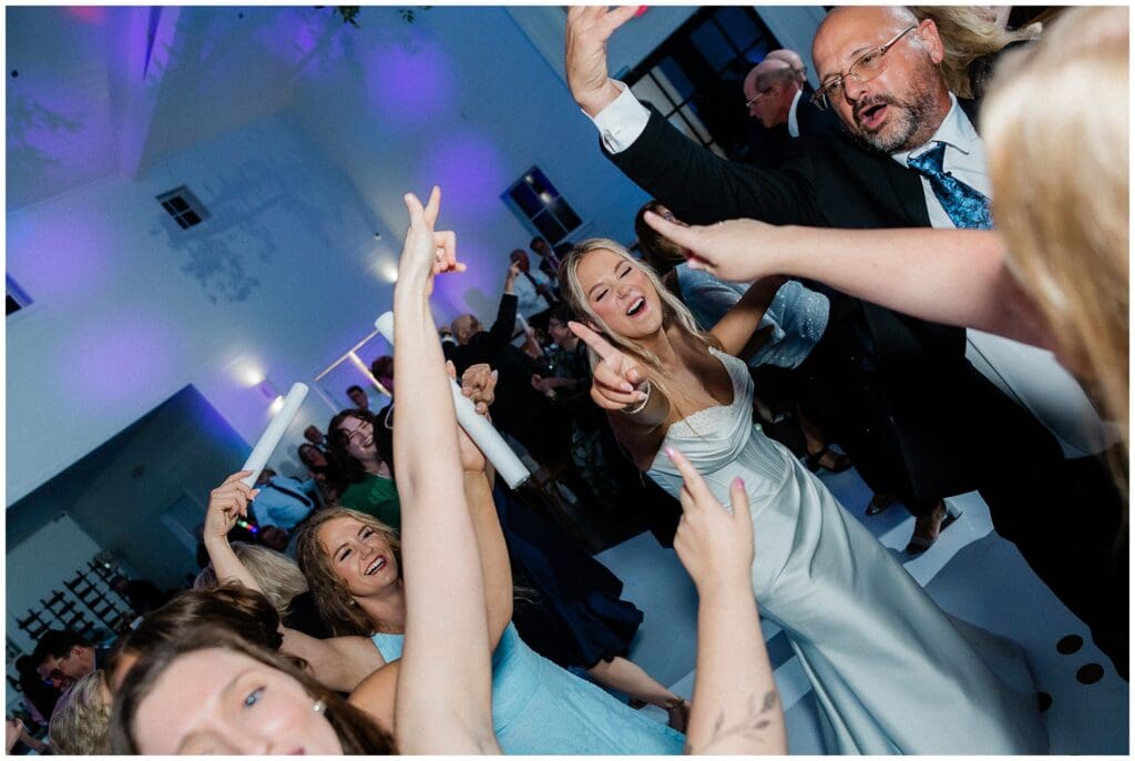 Bride dancing with guests on the dancefloor at Addison Woods