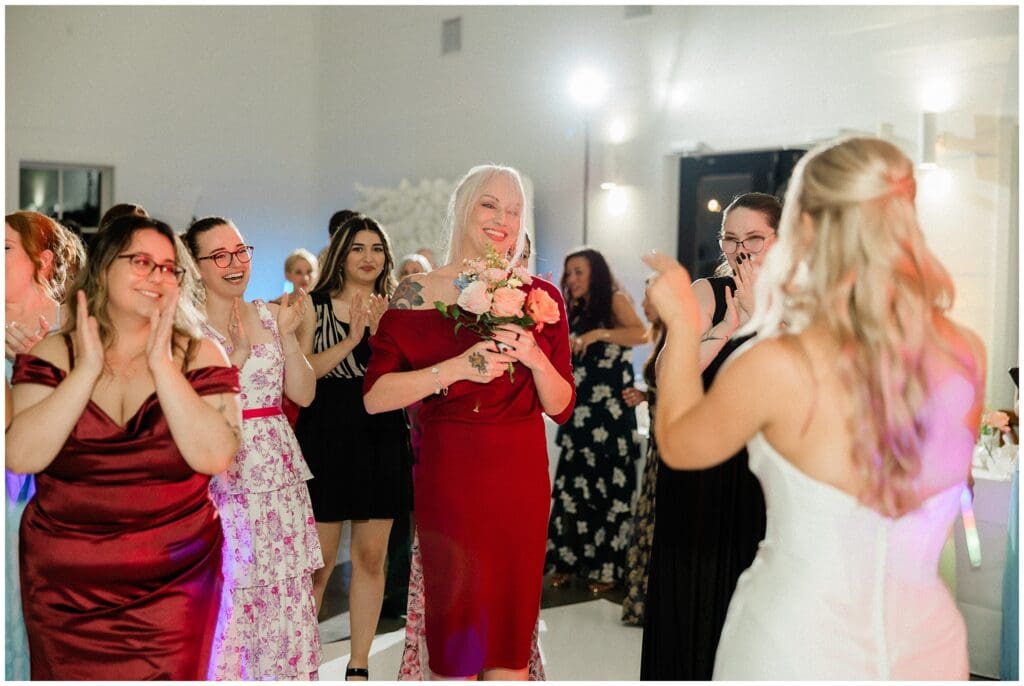 Girl catching the bouquet at Addison Woods