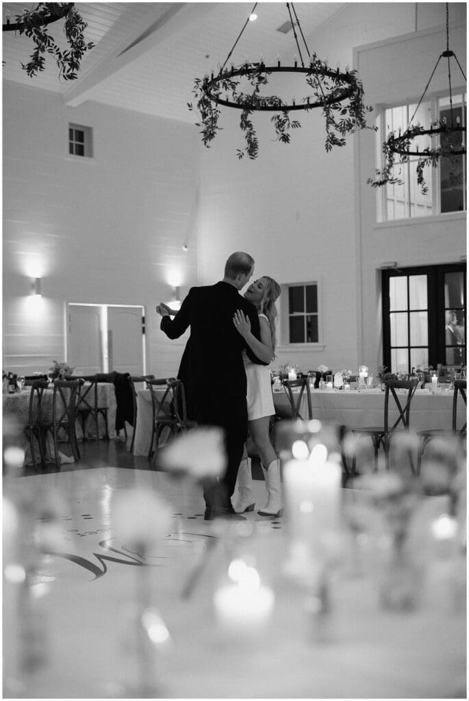 Bride and groom sharing their last dance surrounded by candles and flowers at Addison Woods