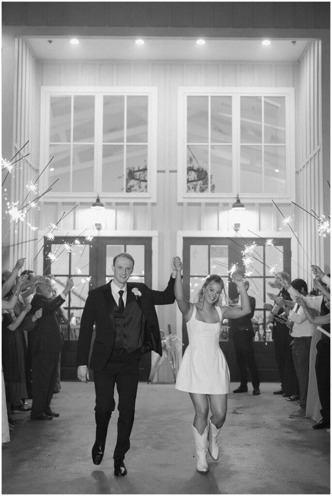 Bride and groom walking through sparkler exit at Addison Woods