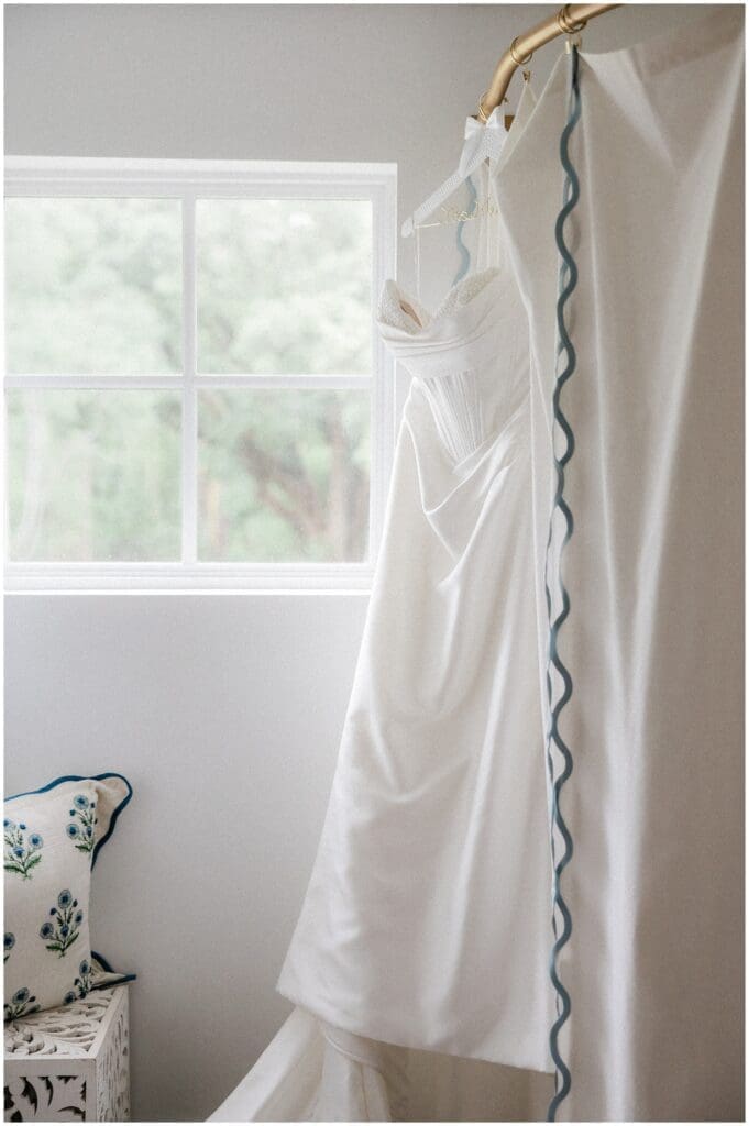 Bride's dress hanging in bridal suite at Addison Woods