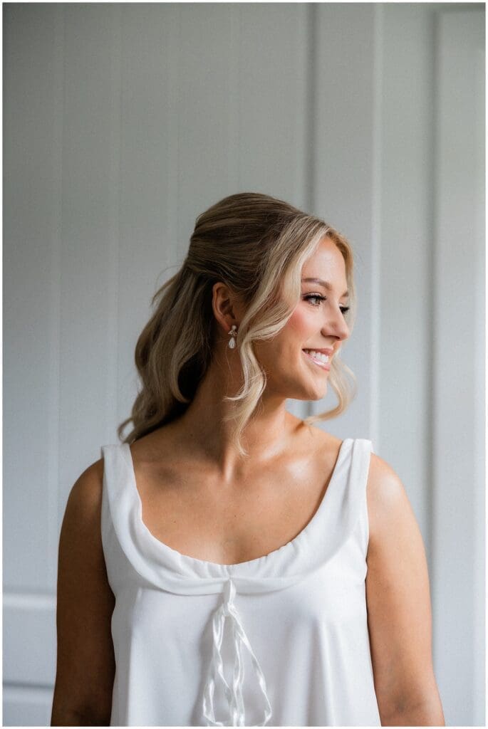 Bride smiling in her bridal pjs at Addison Woods
