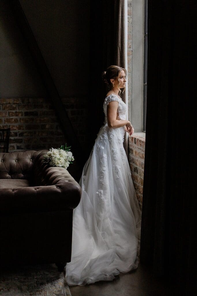 Bride looking out the window at Iron Manor