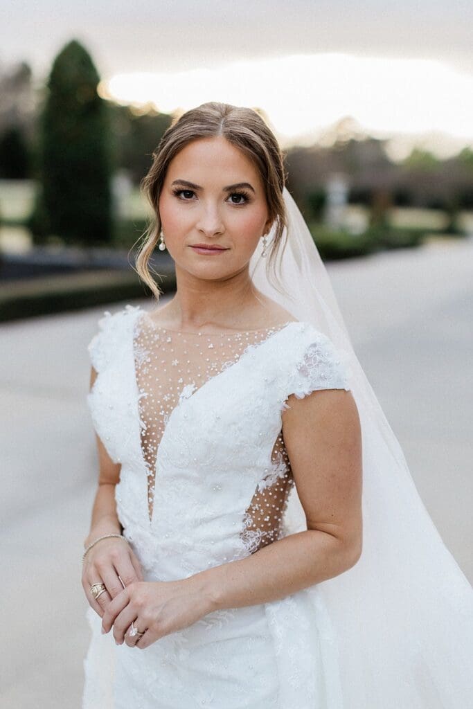 Golden hour bridal portraits of bride looking at camera at iron manor