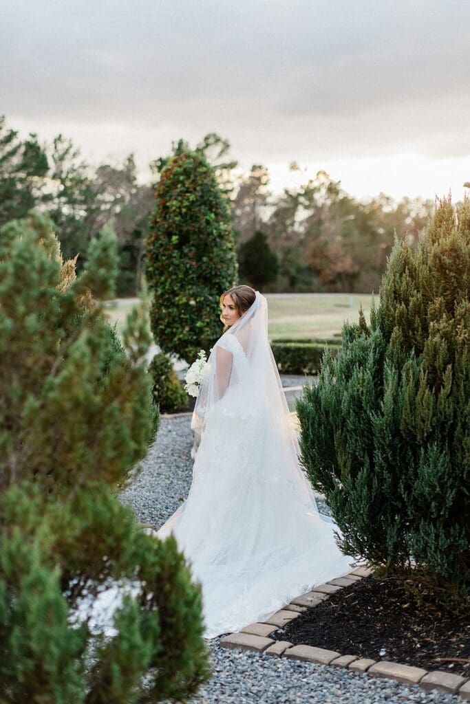 Bride in the garden doing portraits at Iron Manor