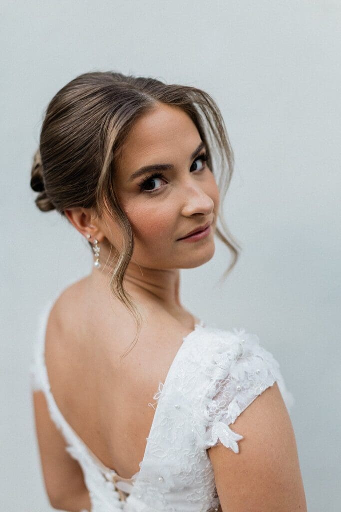 Bride looking back at the camera in the bridal suite at Iron Manor